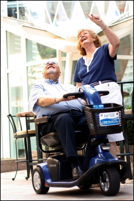 Man on Scooter with Wife Beside